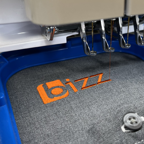 Embroidery machine stitching a logo