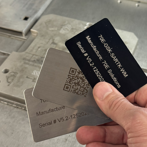 Laser engraving shown on assortment of metal cards