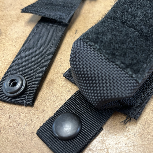 Fasteners sewn onto a tactical flashlight pouch